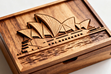 Wooden box with laser-cut Sydney Opera House design on a white background